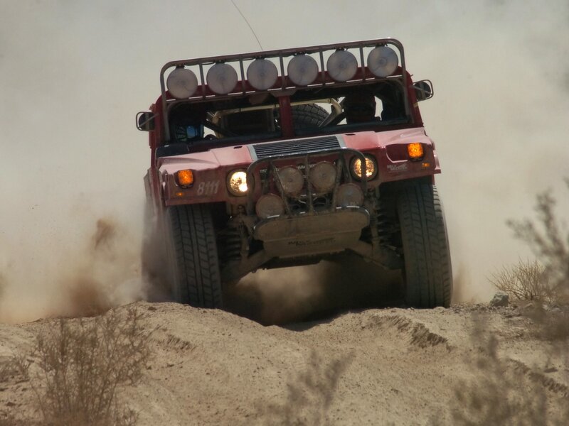Red off-road vehicle on dusty terrain