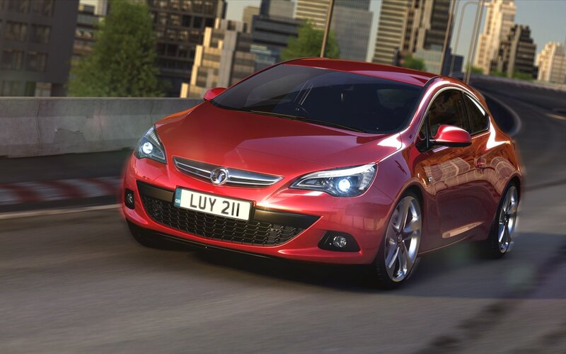 Red Opel Astra driving in city