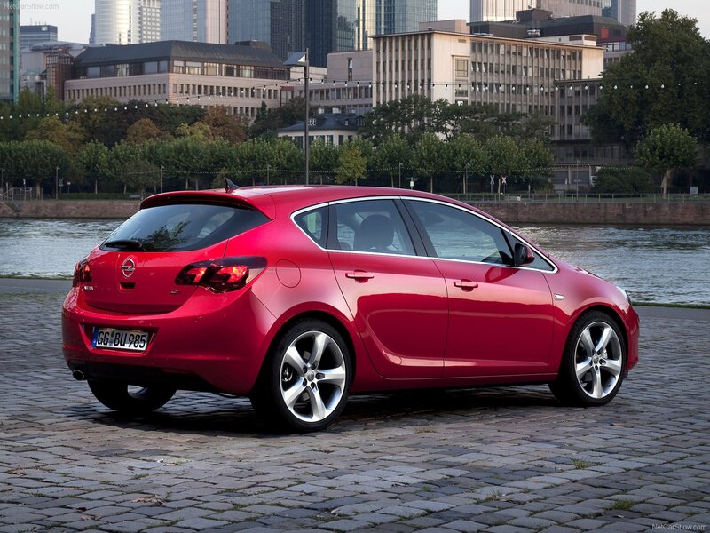 Red Opel Astra parked by river