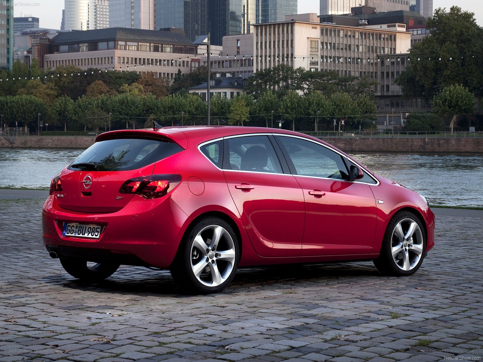Red Opel Astra parked by river