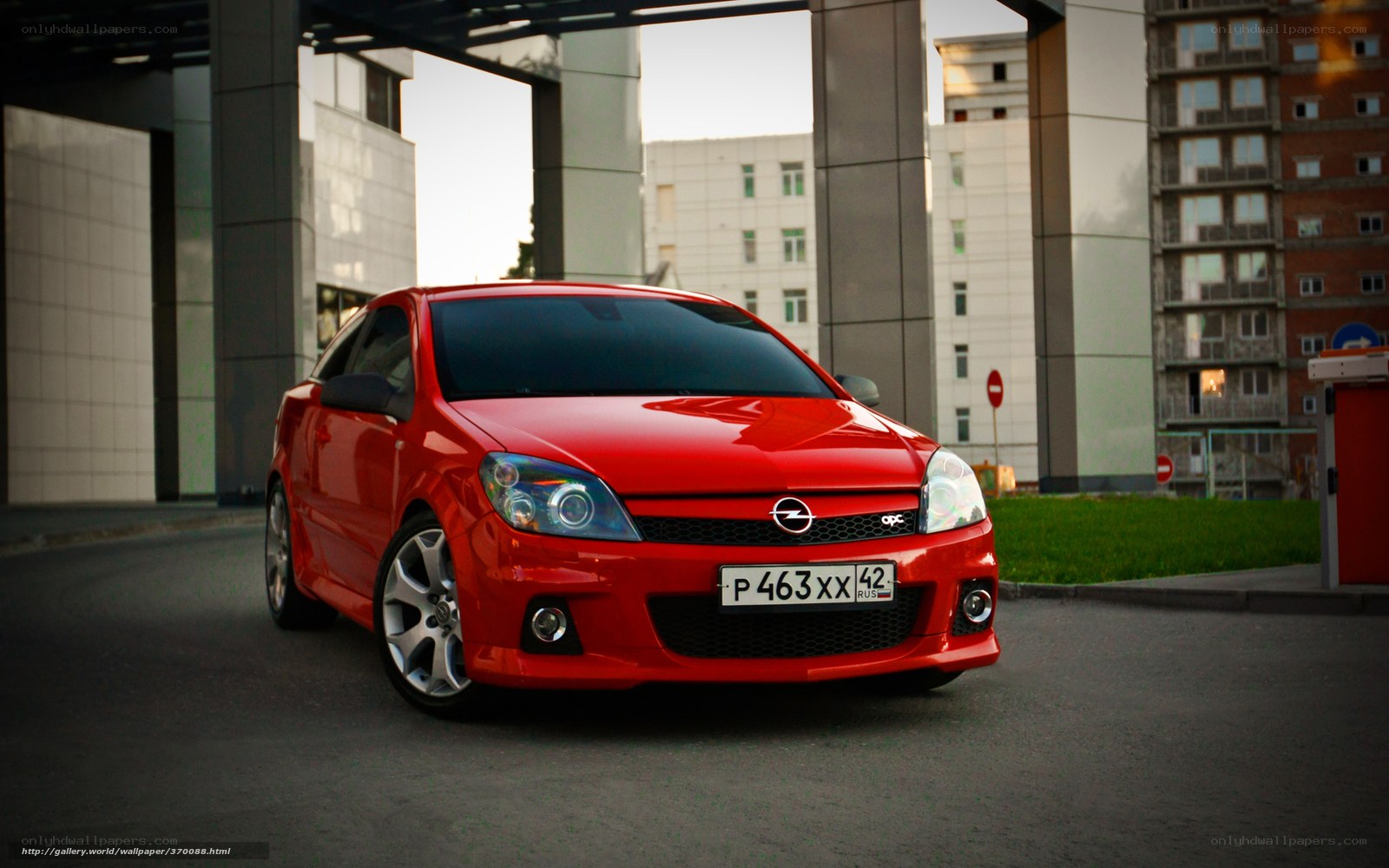 Red Opel Astra parked under overpass