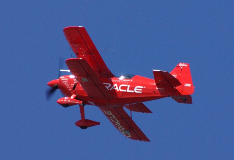 Red Oracle aerobatic plane in flight