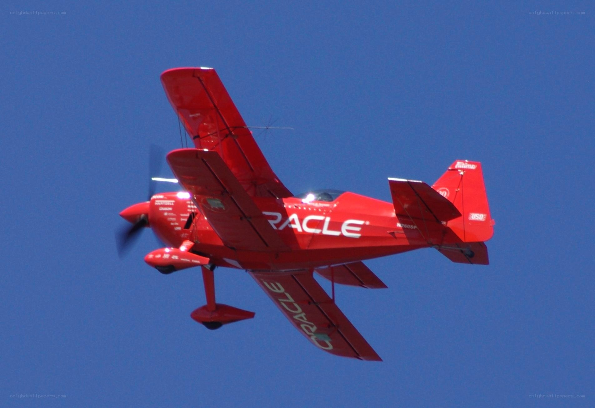 Red Oracle aerobatic plane in flight