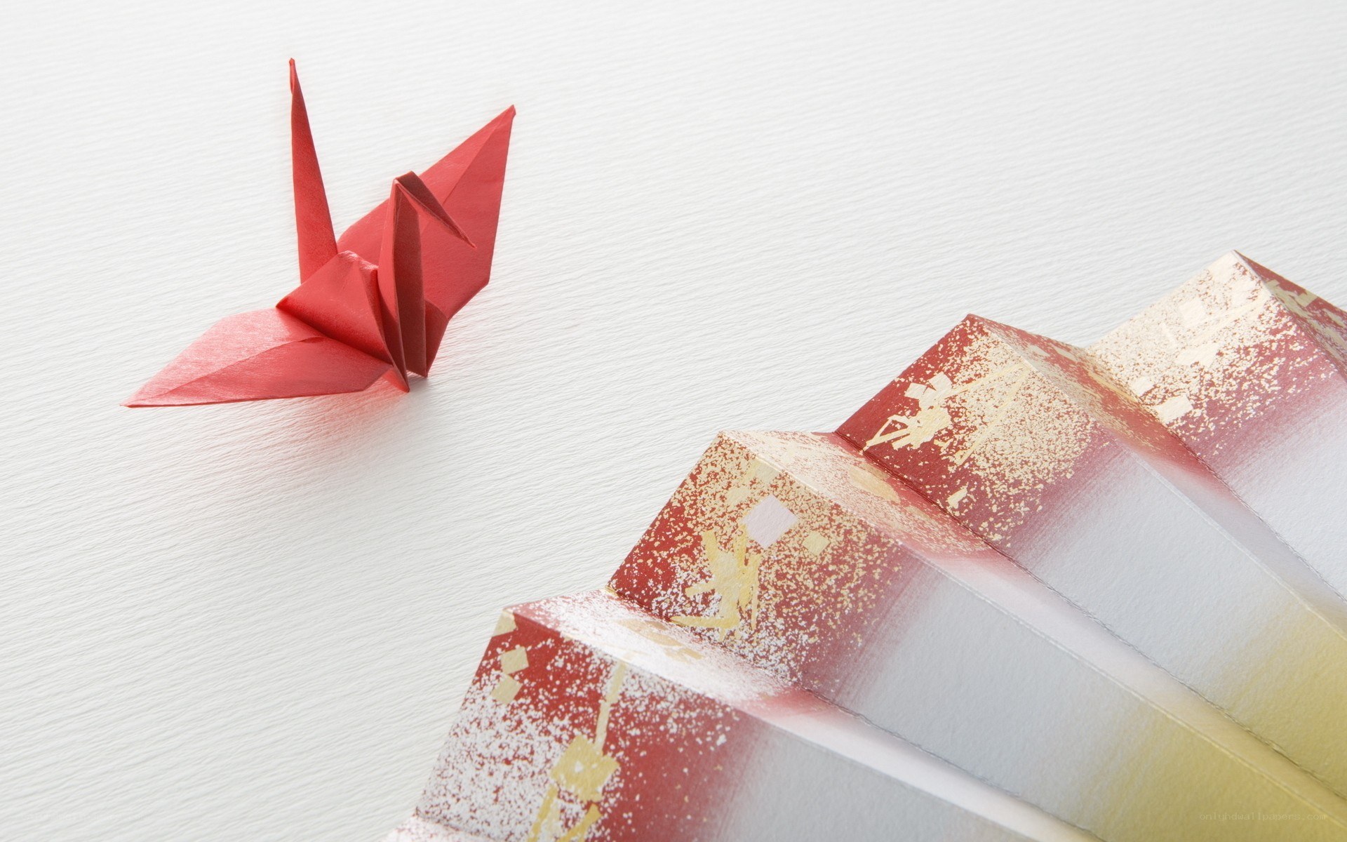 Red origami crane and fan