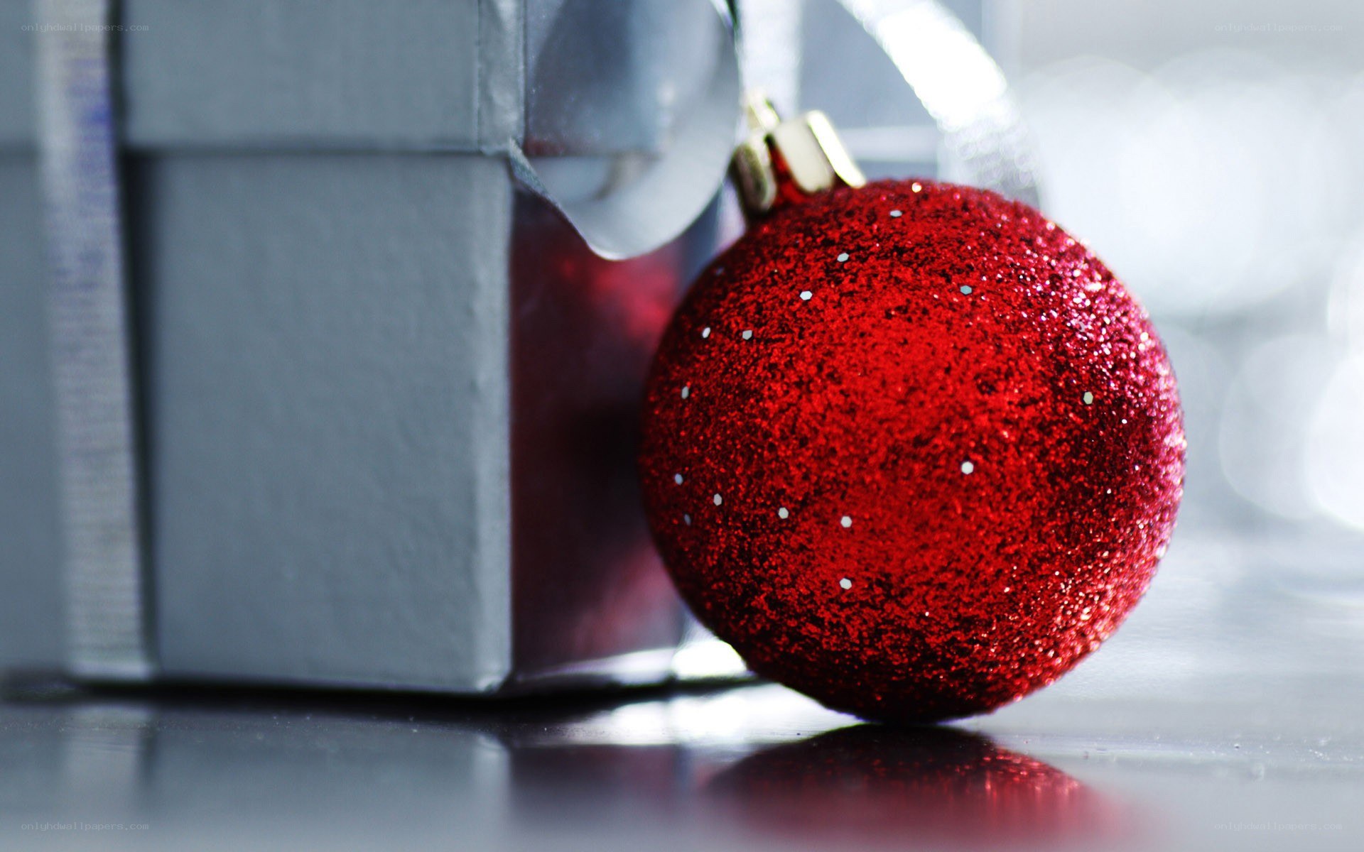 Red ornament beside gift box