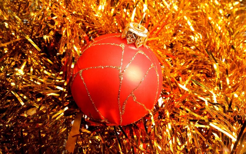 red ornament on gold tinsel