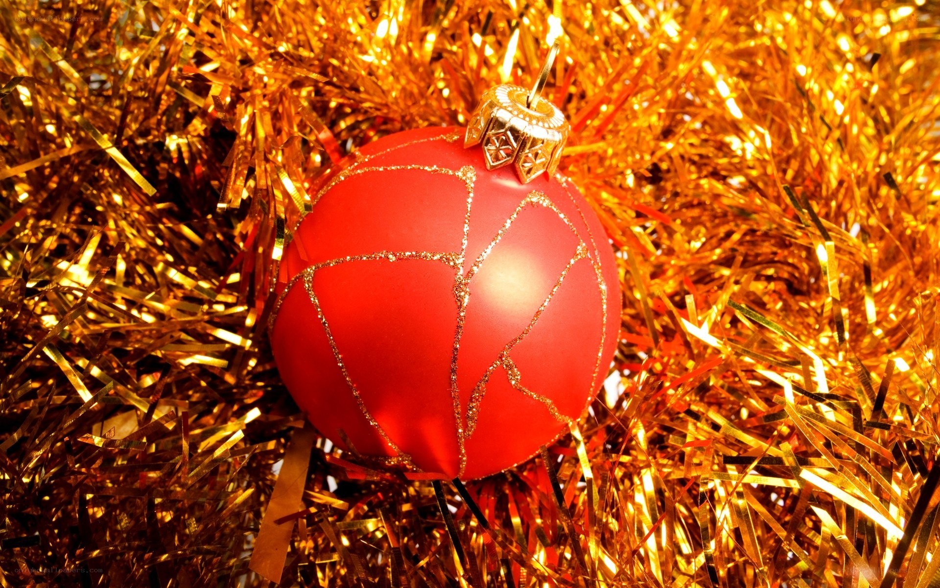 red ornament on gold tinsel