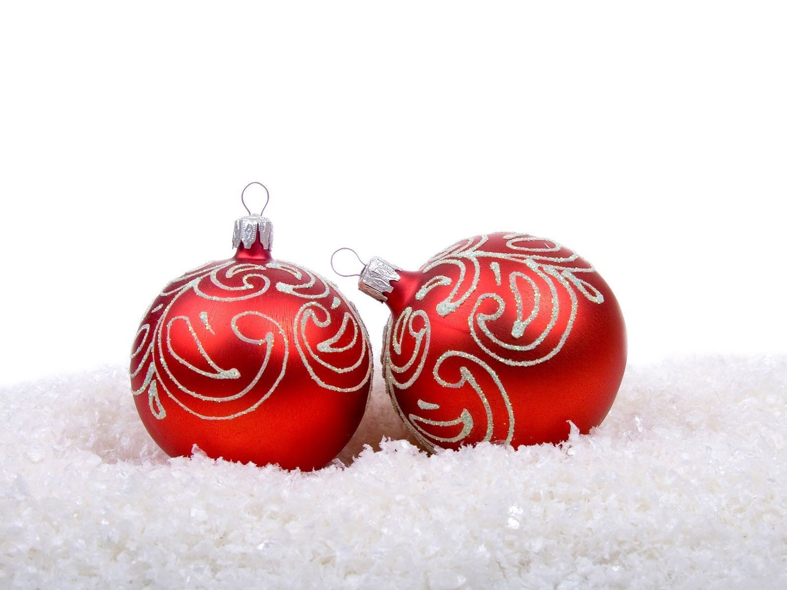 Red ornaments on snow