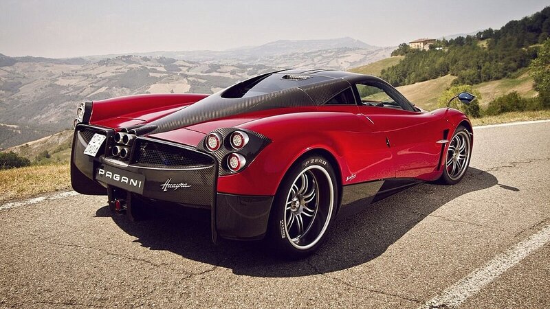 Red Pagani Huayra on a scenic road