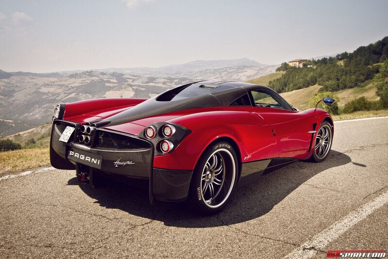 Red Pagani Huayra on a scenic road