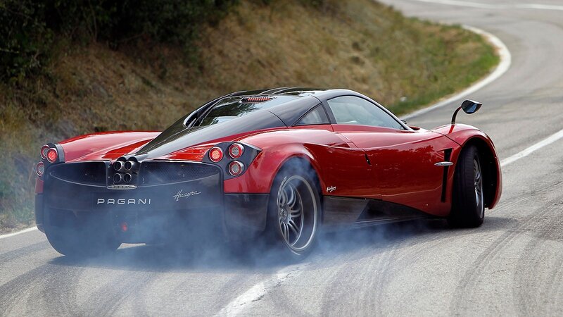 Red Pagani Huayra on a winding road
