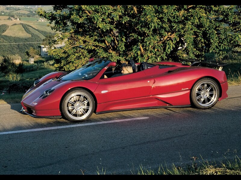 Red Pagani roadster on a scenic drive