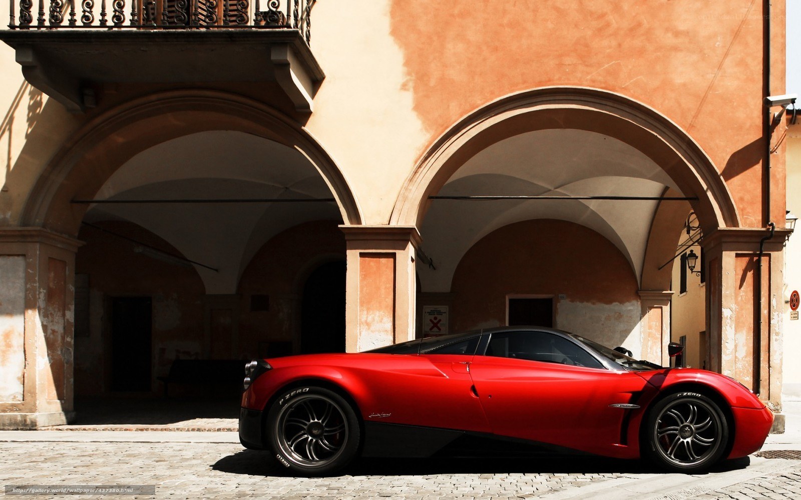 Red Pagani sports car in courtyard