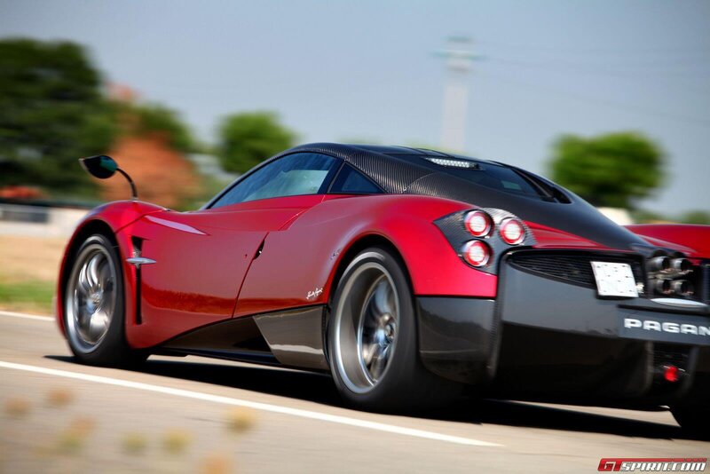 red Pagani sports car in motion