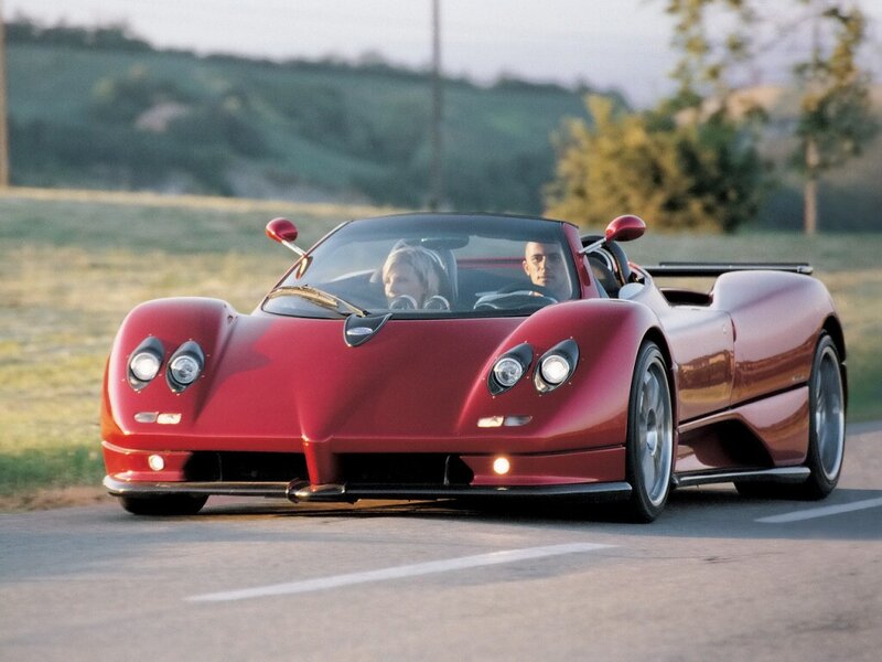 Red Pagani sports car on road