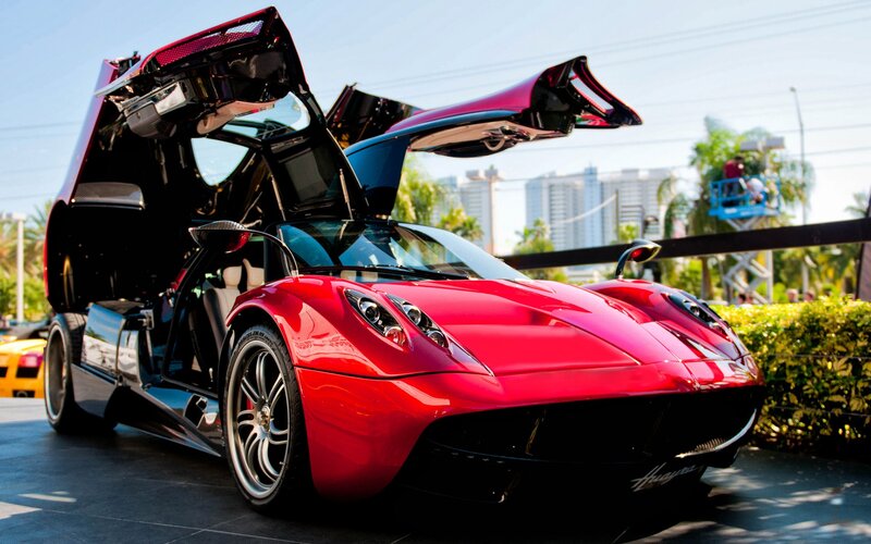 Red Pagani sports car with doors open