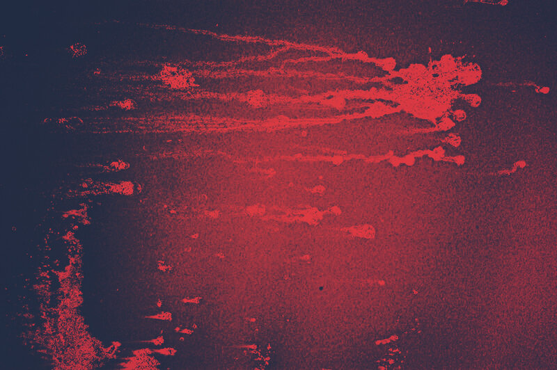 red paint splatter on dark surface