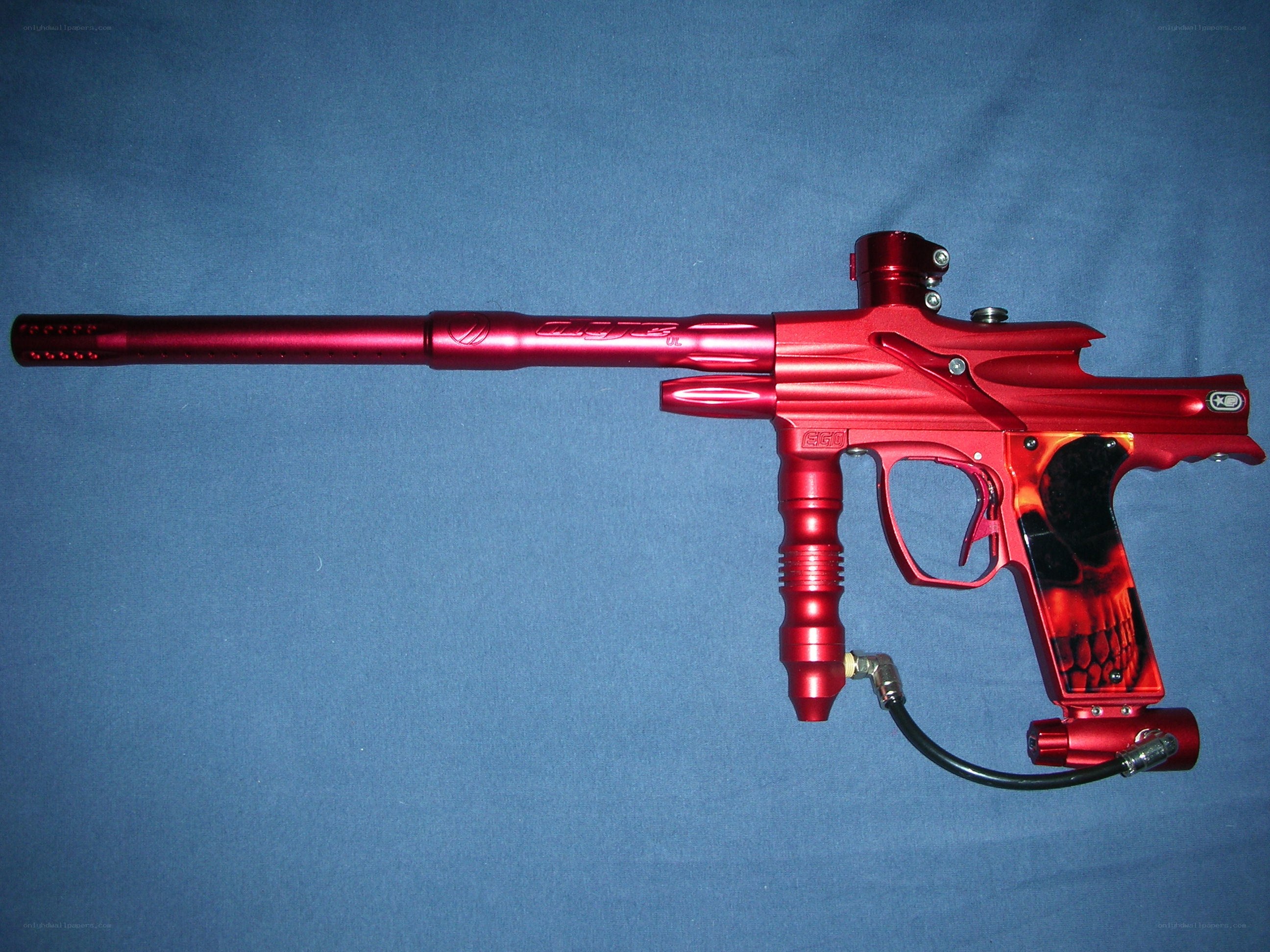 red paintball gun with skull grip