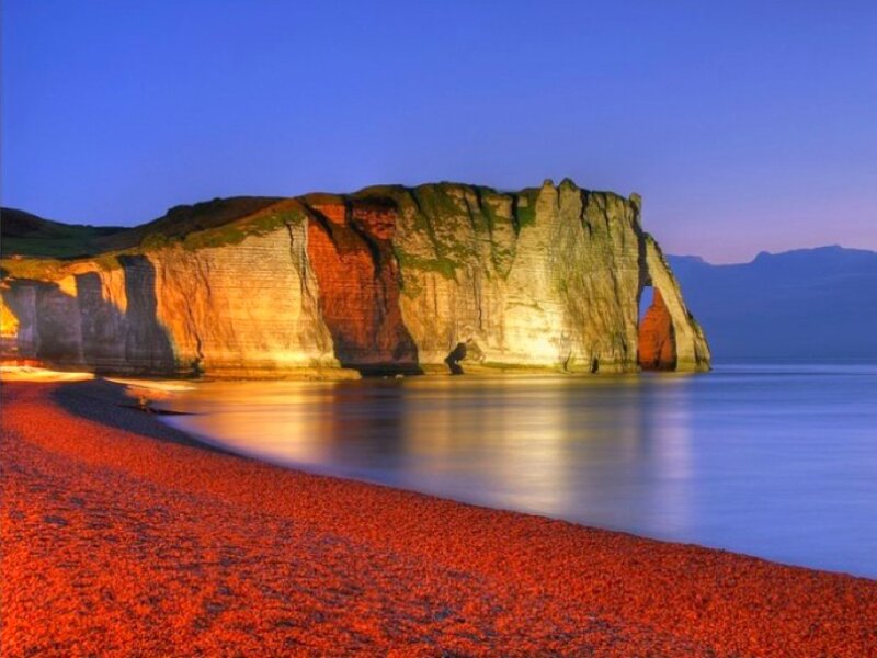 Red pebble beach at dusk