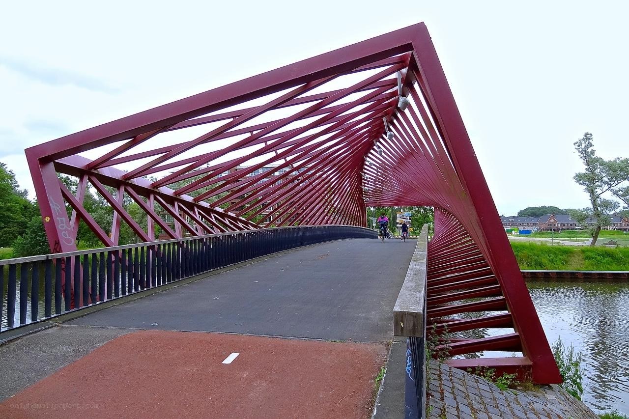 Red pedestrian bridge over canal