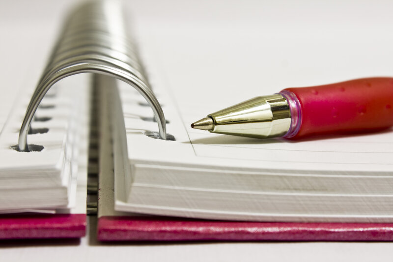 red pen on notebook