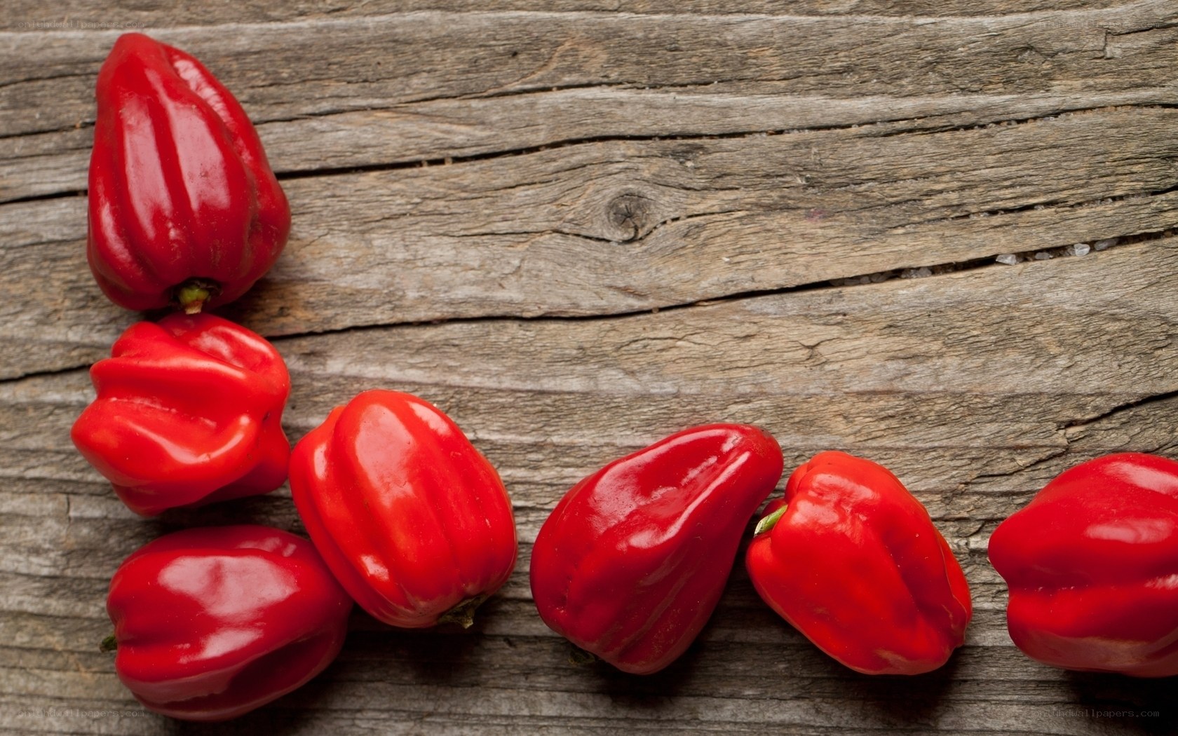 Red peppers on wooden surface