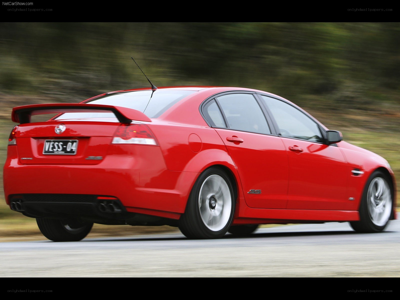red performance sedan in motion
