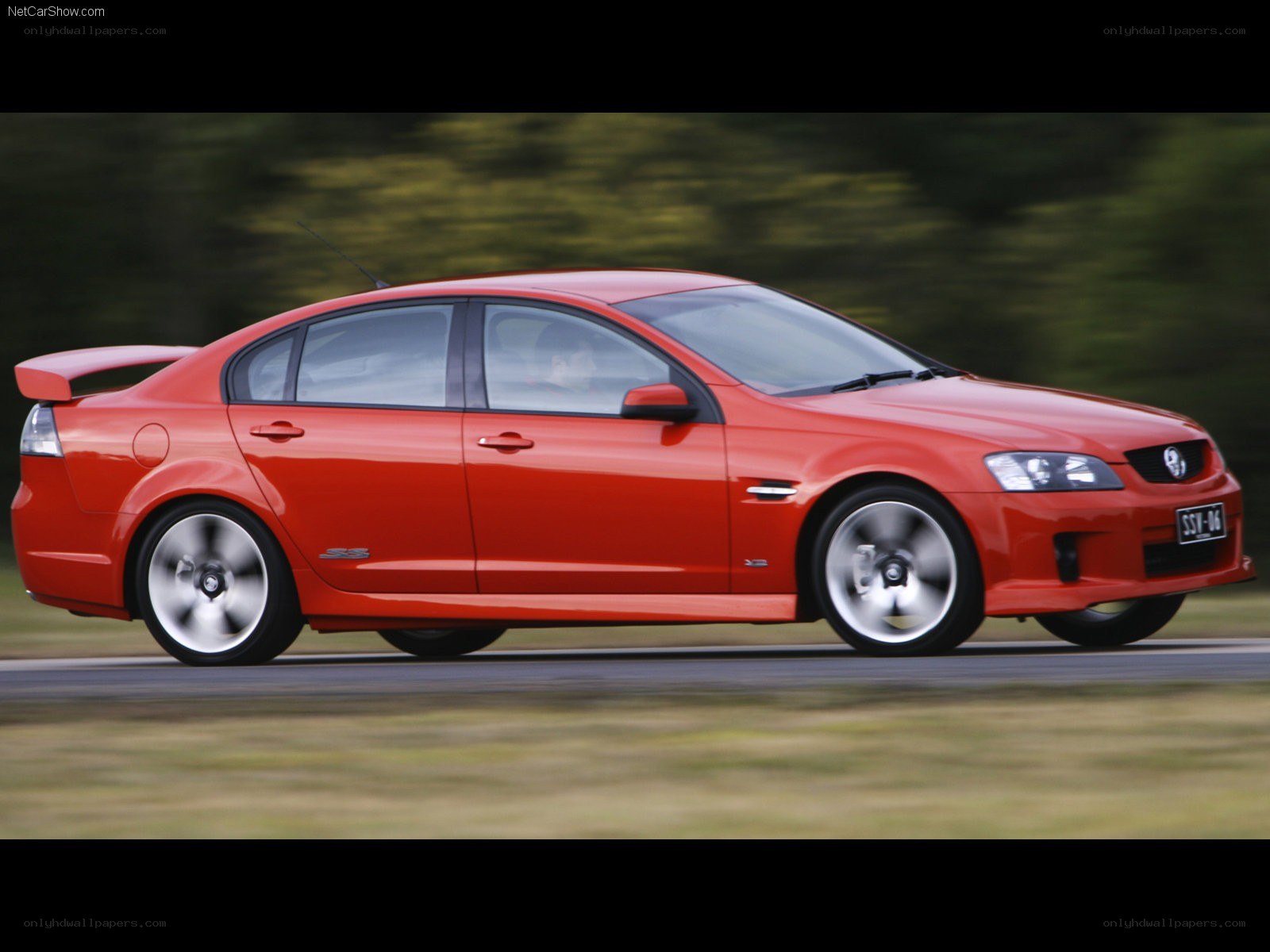 red performance sedan in motion