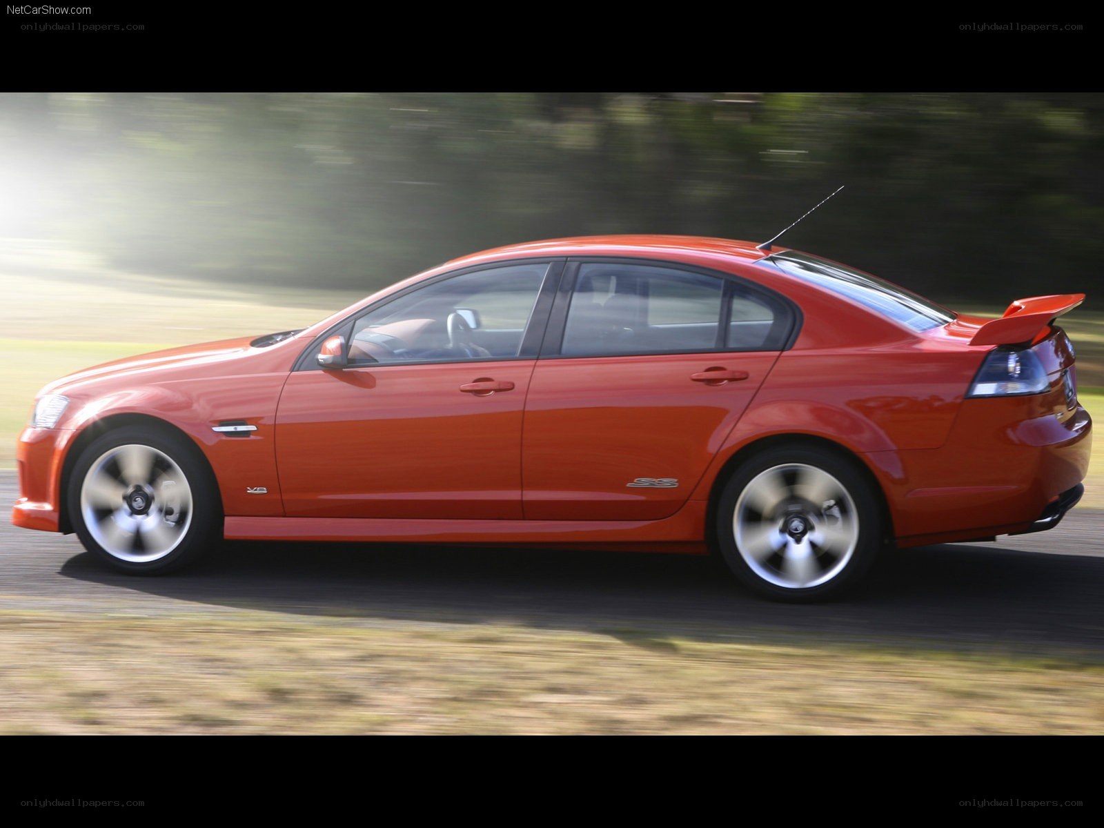 red performance sedan in motion