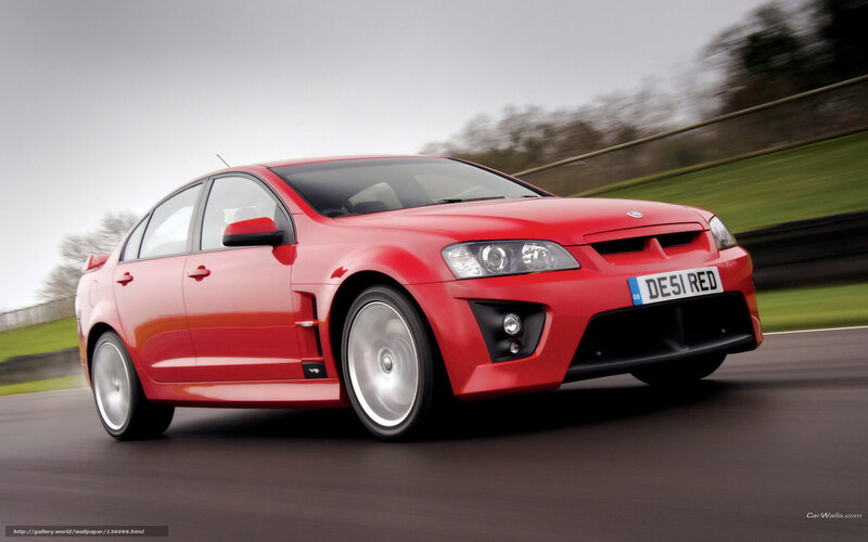 red performance sedan in motion