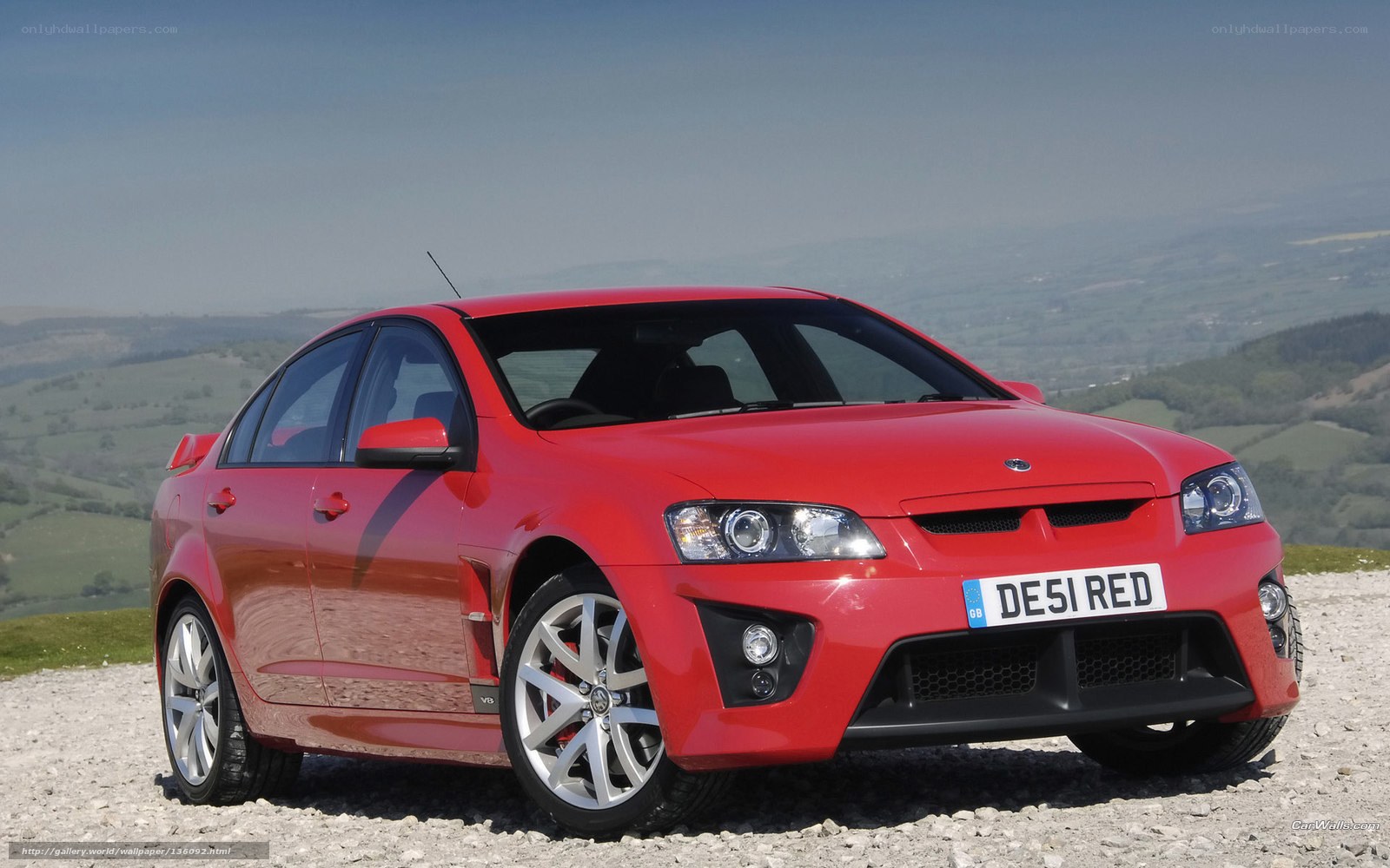 red performance sedan on hilltop