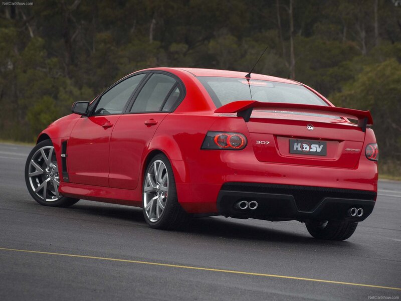 red performance sedan on road