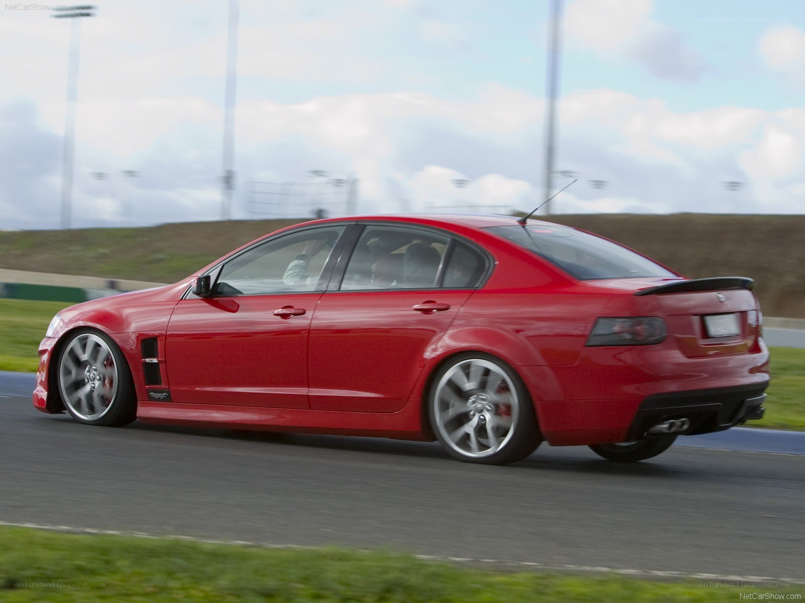 red performance sedan on track