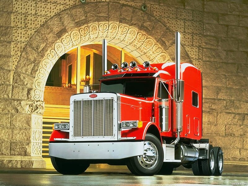 Red Peterbilt truck in stone archway