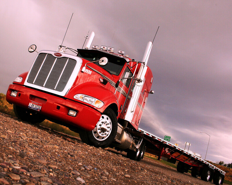 Red Peterbilt truck on gravel