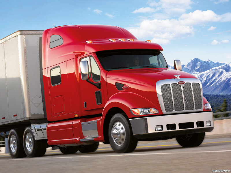 Red Peterbilt truck on highway