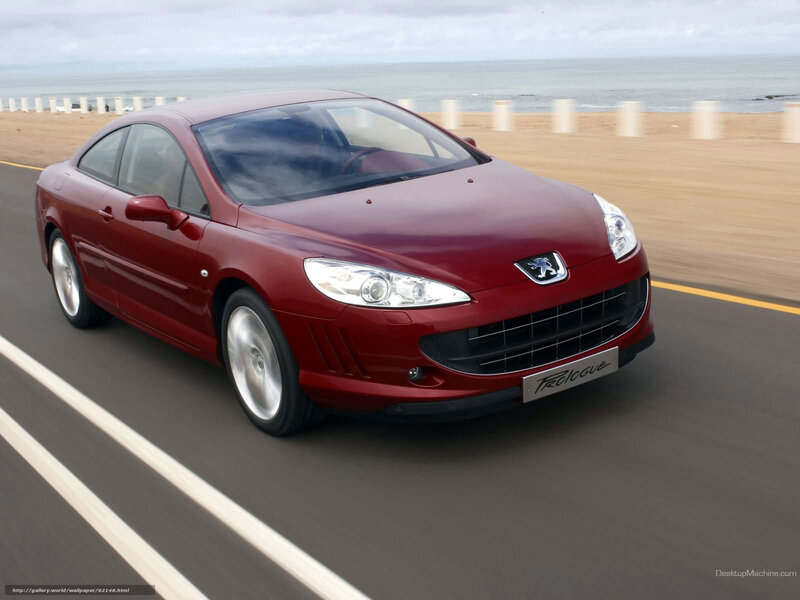 red peugeot coupe on coastal road