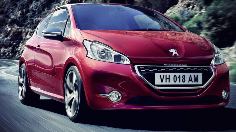 Red Peugeot driving on a road