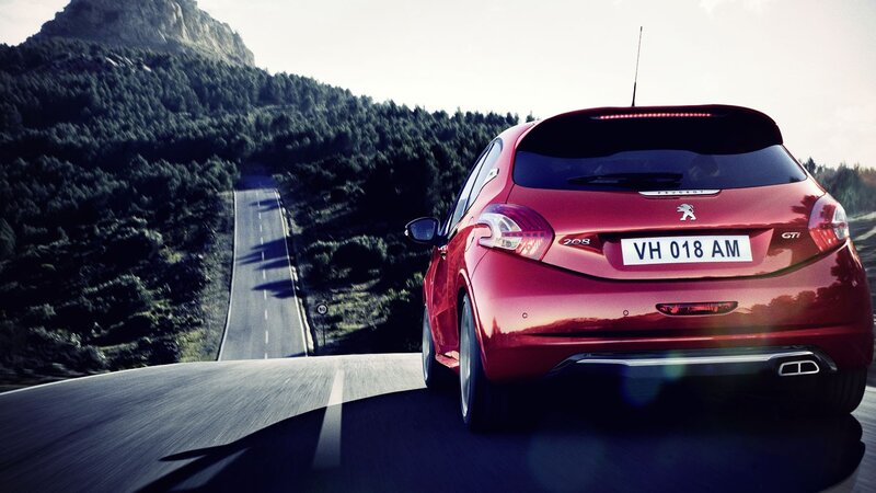 Red Peugeot on mountain road