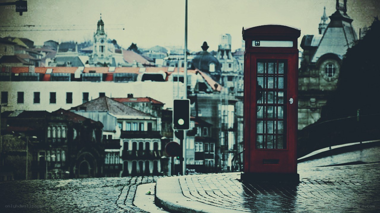 Red phone booth in city