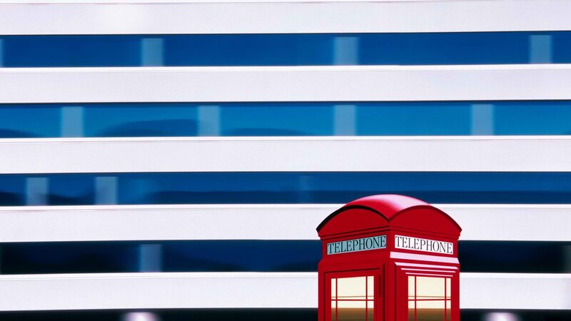 Red phone booth in city