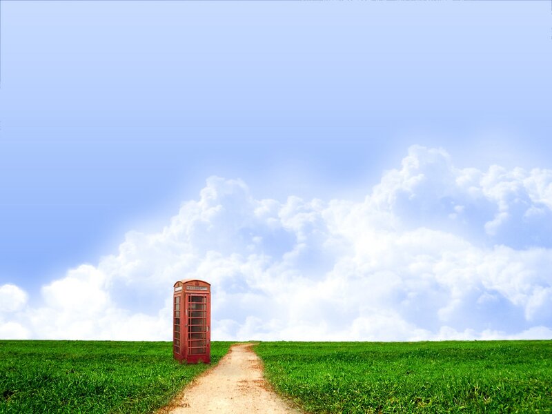 Red phone booth in green field