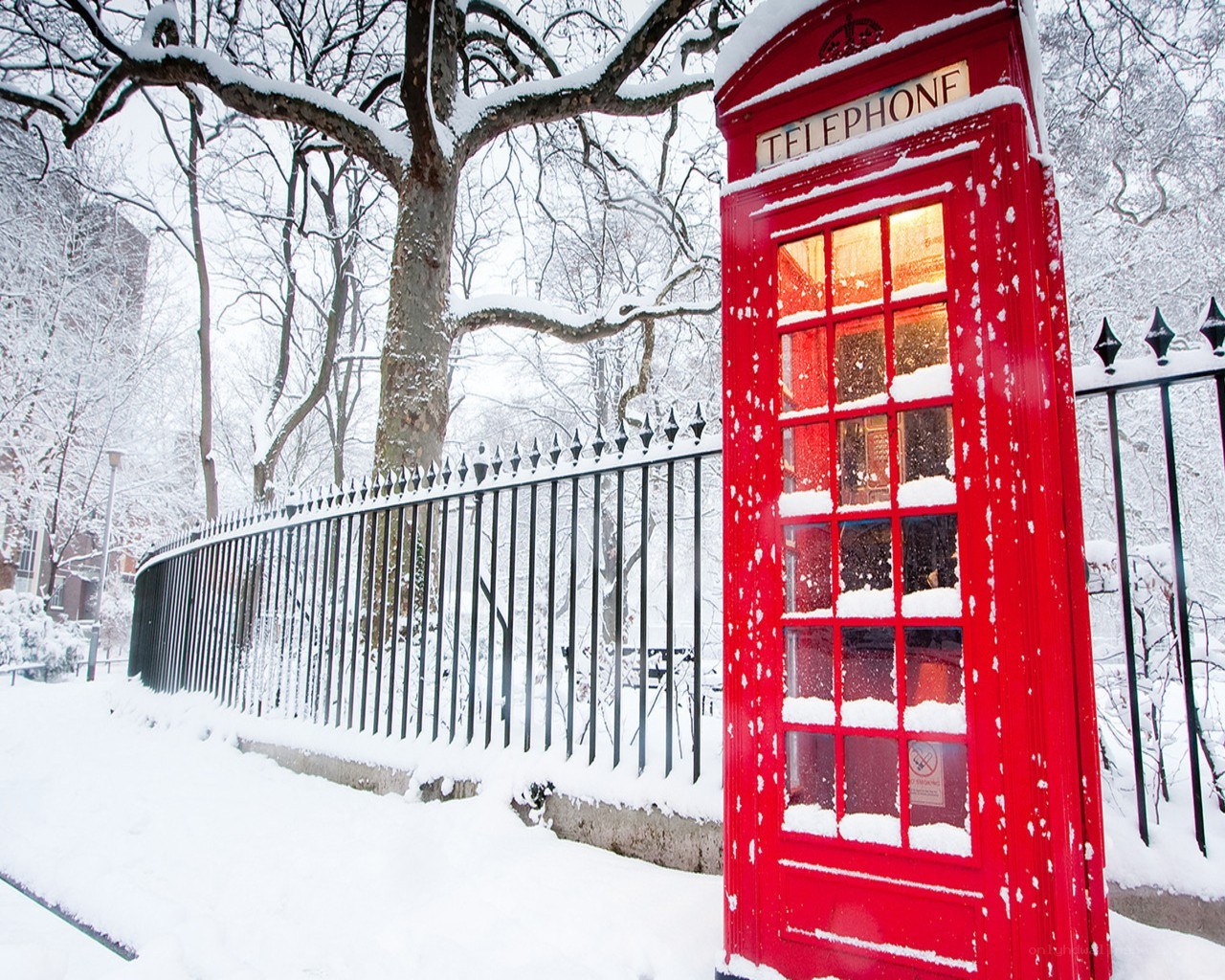 Red phone booth in snow