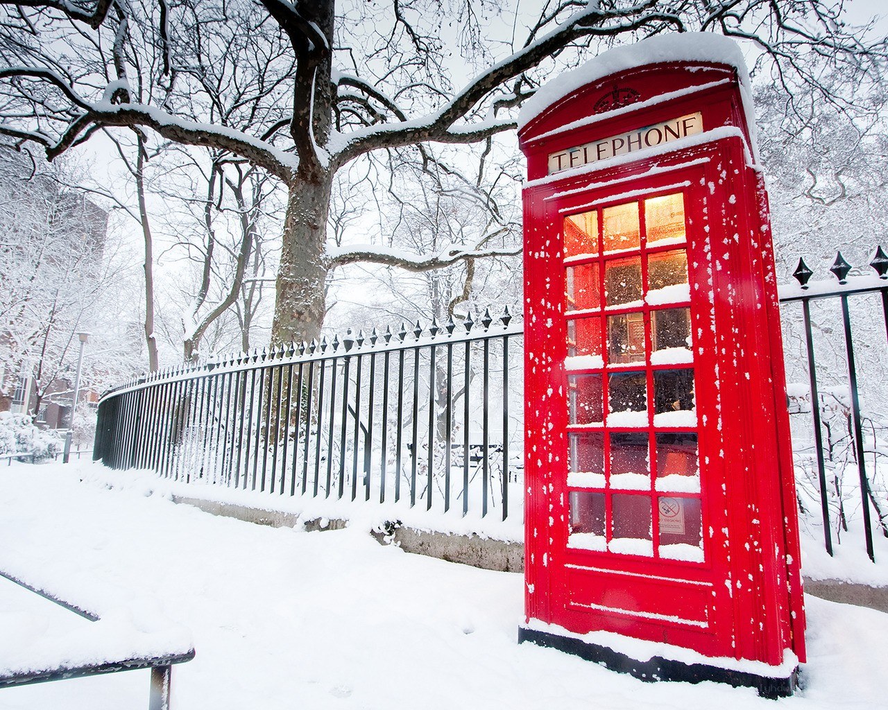 Red phone booth in snow