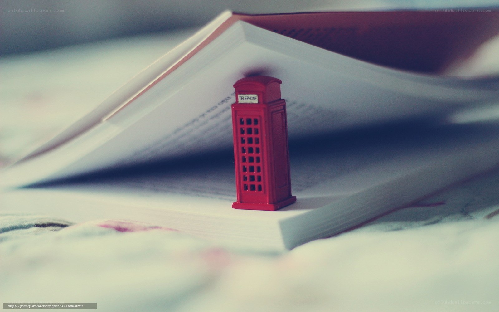 Red phone booth on open book