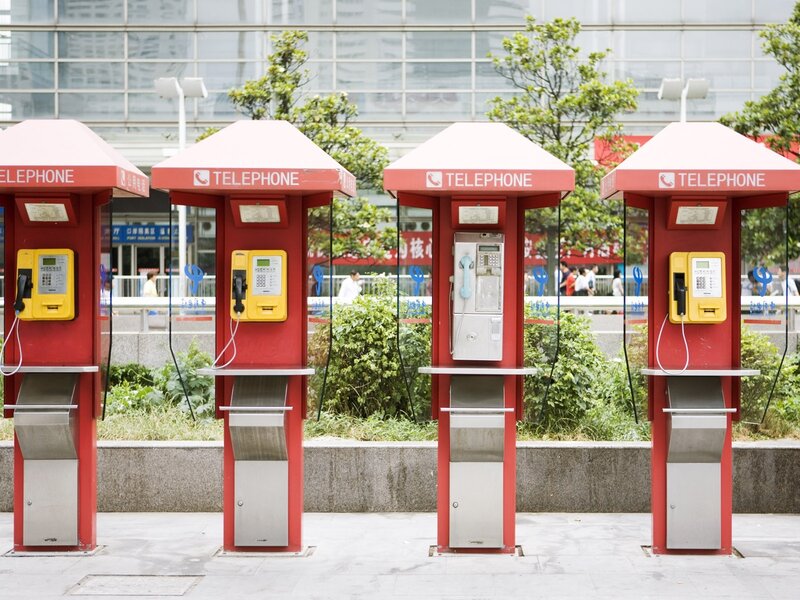 Red phone booths in a city