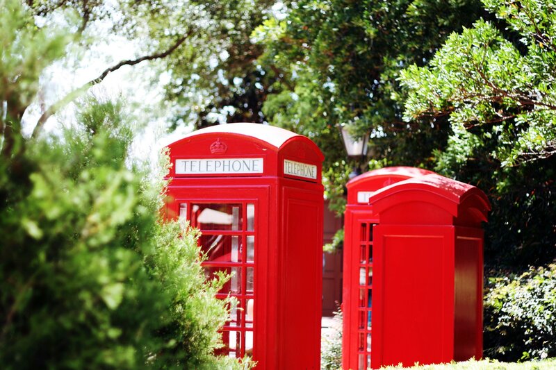 Red phone booths in a park