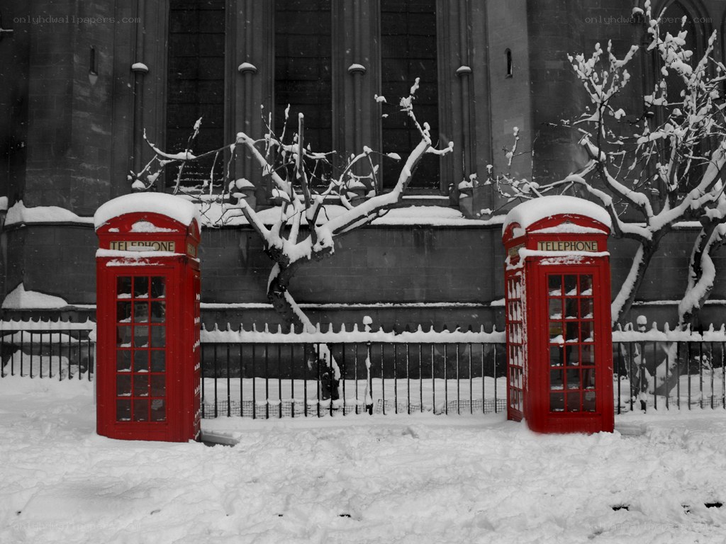 Red phone booths in snow