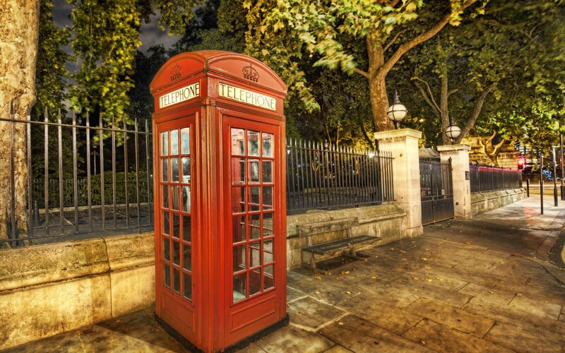 Red phone box at night