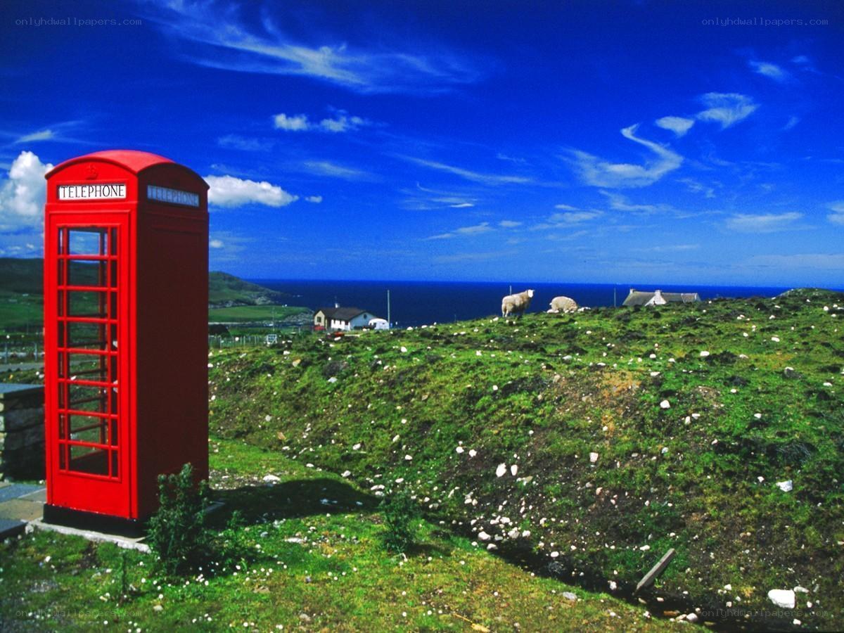 Red phone box on a hillside